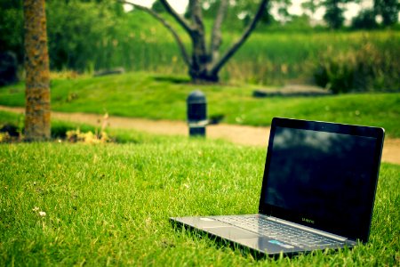 Gray and Black Laptop Computer on Grass Lawn Outdoors photo