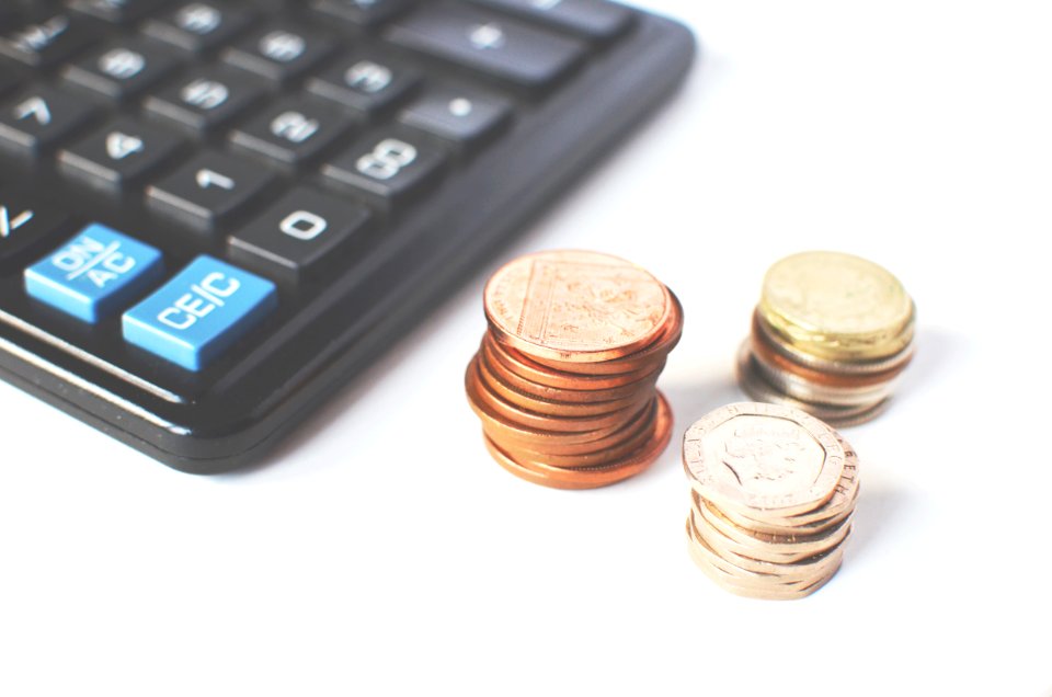 Gold-colored Coins Near Calculator photo