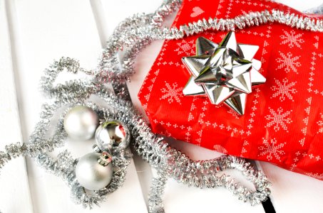 Several Silver Bauble Balls Beside Red Wrapper photo