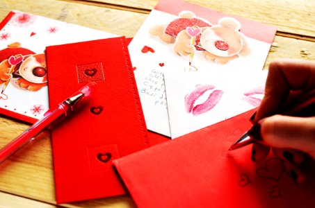 Person Holding Pen While Writing a Heart photo