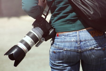 Person Carrying Black Dslr Camera photo