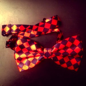 Red and Black Checkered Bow on Black Surface