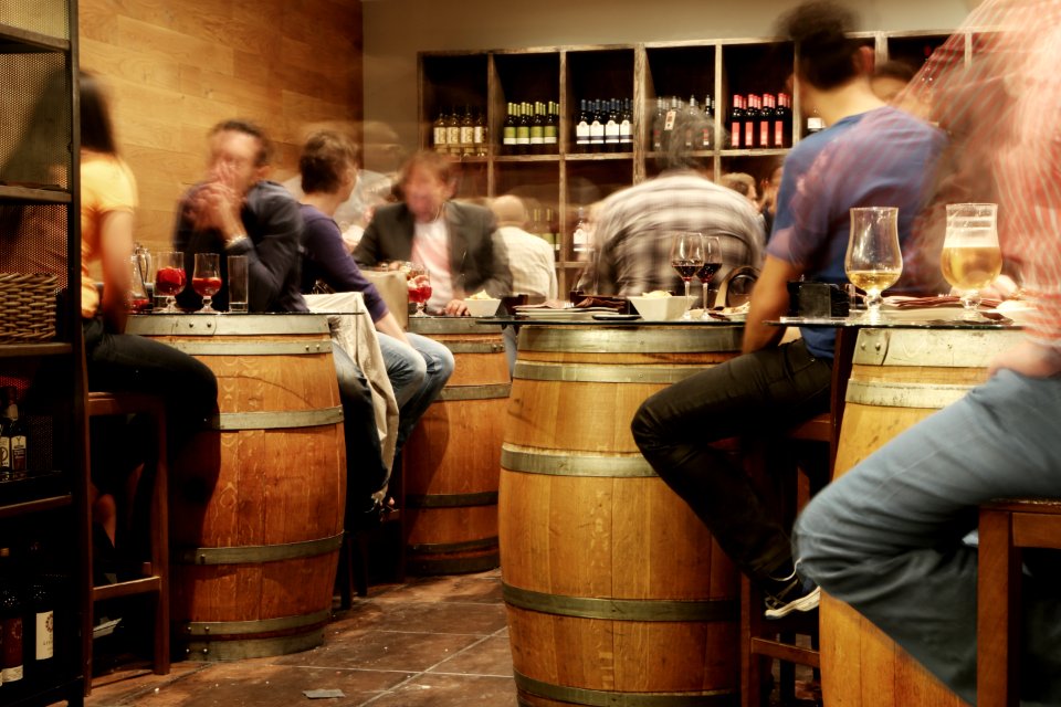 Person Sitting Near the Brown Wooden Barrel Table photo