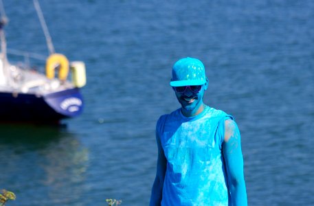 Man Covered With Blue Paint Near Body of Water photo