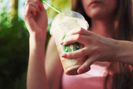 Woman Holding Starbucks Coffee Cup photo