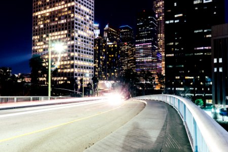 Time-lapse Photography of Bridge Near Buildings at Night photo