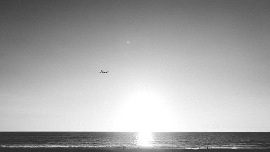 Airplane Flying Above Ocean photo