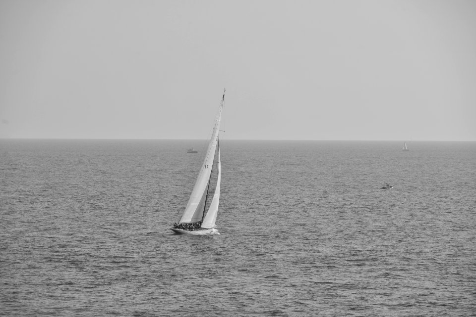 Grayscale Photography of Boat on Calm Body of Water photo