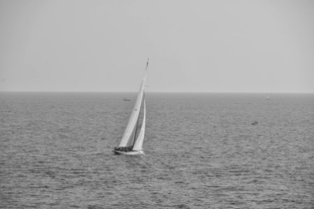 Grayscale Photography of Boat on Calm Body of Water photo