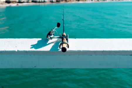 Fishing Rod on White Wooden Beam photo