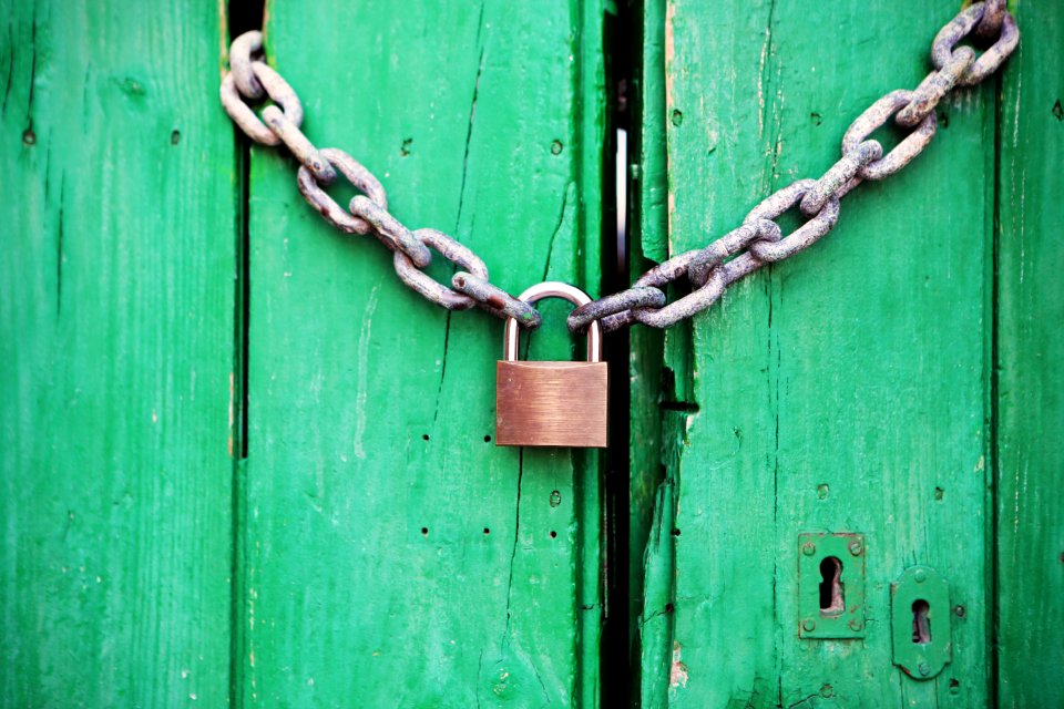 Brass-colored Metal Padlock With Chain photo