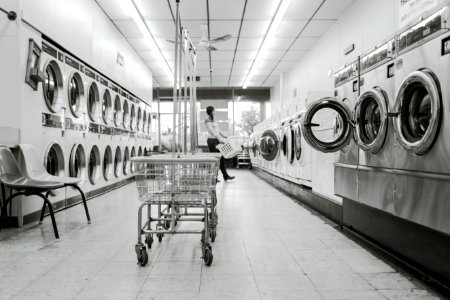 Grayscale Photography of Woman in Laundry Shop