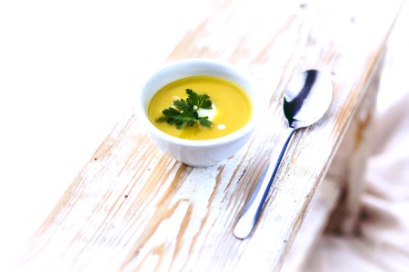 Leek and potato soup in white bowl photo