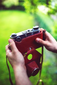 Old analog camera in the hands photo