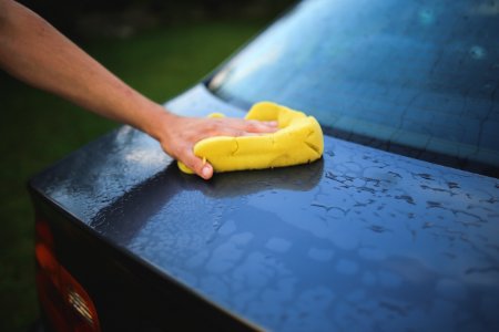 Washing a car with a sponge photo