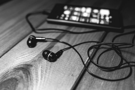 Black earphones on a desk photo