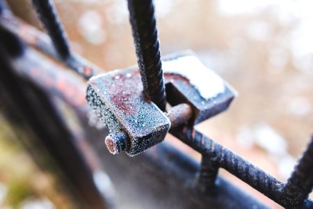 Rusty padlock covered with hoarfrost ice crystals