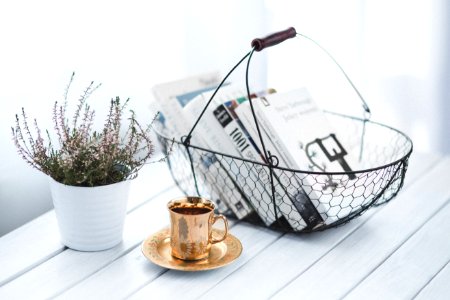 Golden cup and basket with books photo