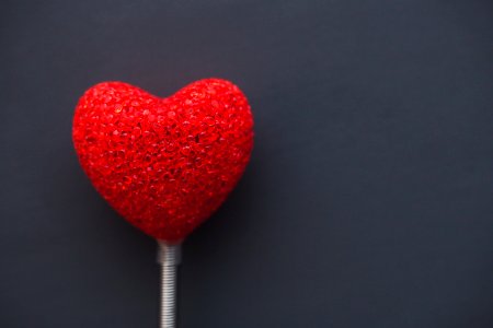 Big red heart on dark background photo