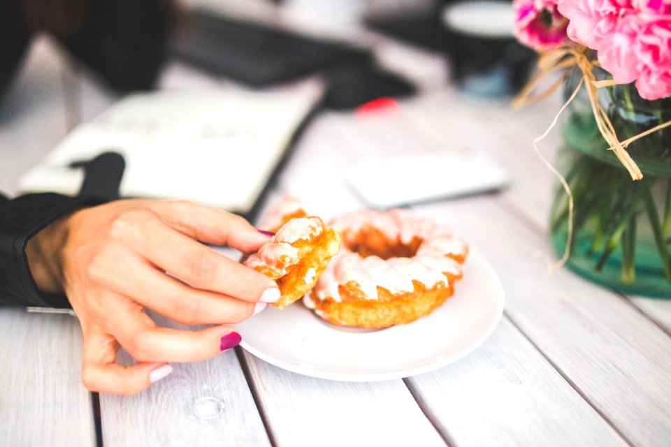 Closeup photo of hand choosing donut