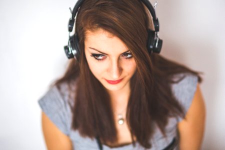 Portrait of young attractive girl listening to music with headphones photo
