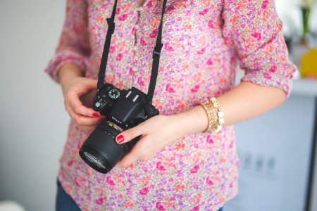 Female photographer holding a dslr camera photo