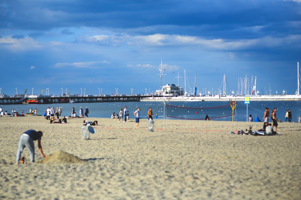 People on the beach. Pier & marina