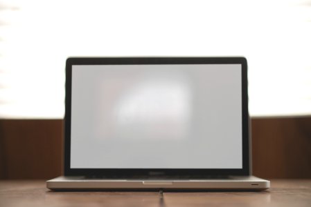 Macbook Pro With White Screen on Brown Surface