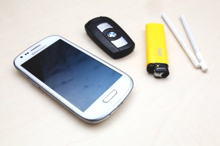 Phone, car key, lighter & cigarettes photo