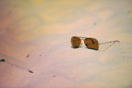 Rule of Thirds Photography of Brown Sunglasses on Sand photo