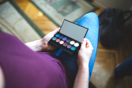 Woman holding the box with eyeshadows photo