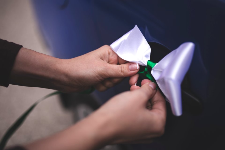 Woman tying a white bow photo