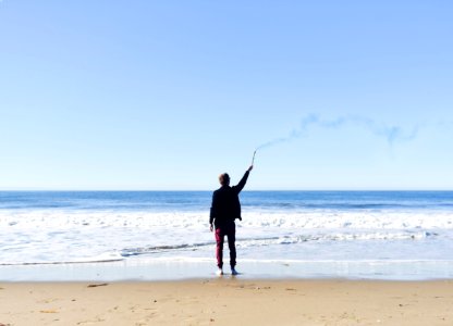 Person Standing on Seashore photo