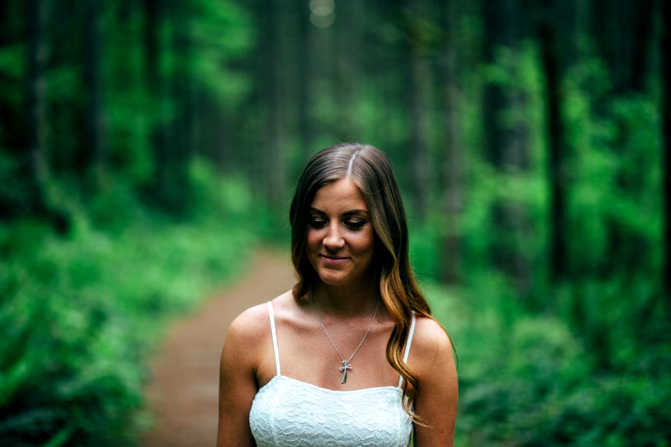 Focus Photography of Smiling Woman Wearing White Spaghetti Strap Top