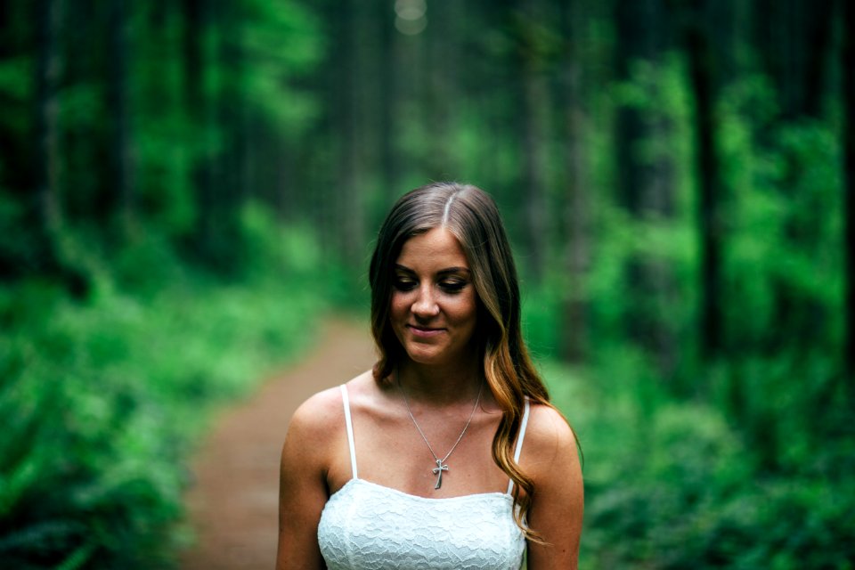 Focus Photography of Smiling Woman Wearing White Spaghetti Strap Top photo