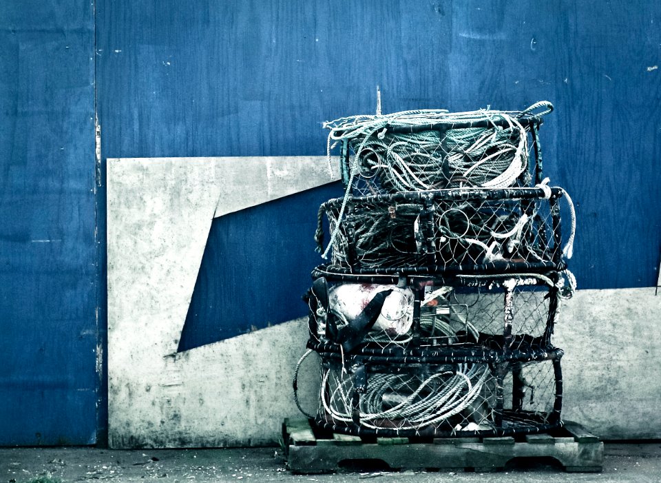 Black Metal 4-layer Rack Beside Blue and Gray Painted Wall
