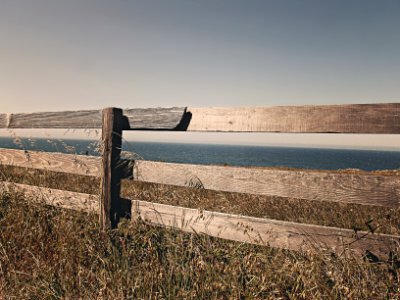 Brown Wooden Fence Near Body of Water photo