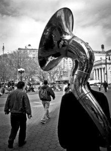 Grayscale Photo of Man Carrying Percussion Instrument photo