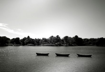 Three Punt Boats on Body of Water photo