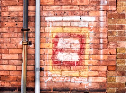 Gray Pipe on Brick Wall photo