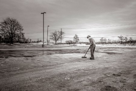 Person Sweeping Pavement photo