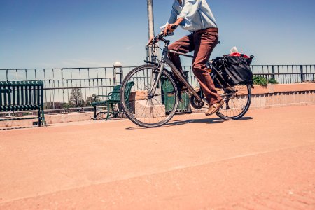 Man Riding Commuter Bike Near Road in Close-up Photography photo