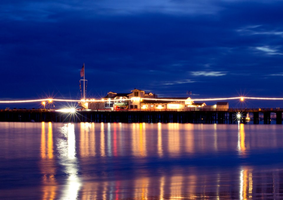 Lighted Houses Near Ocean during Nighttime