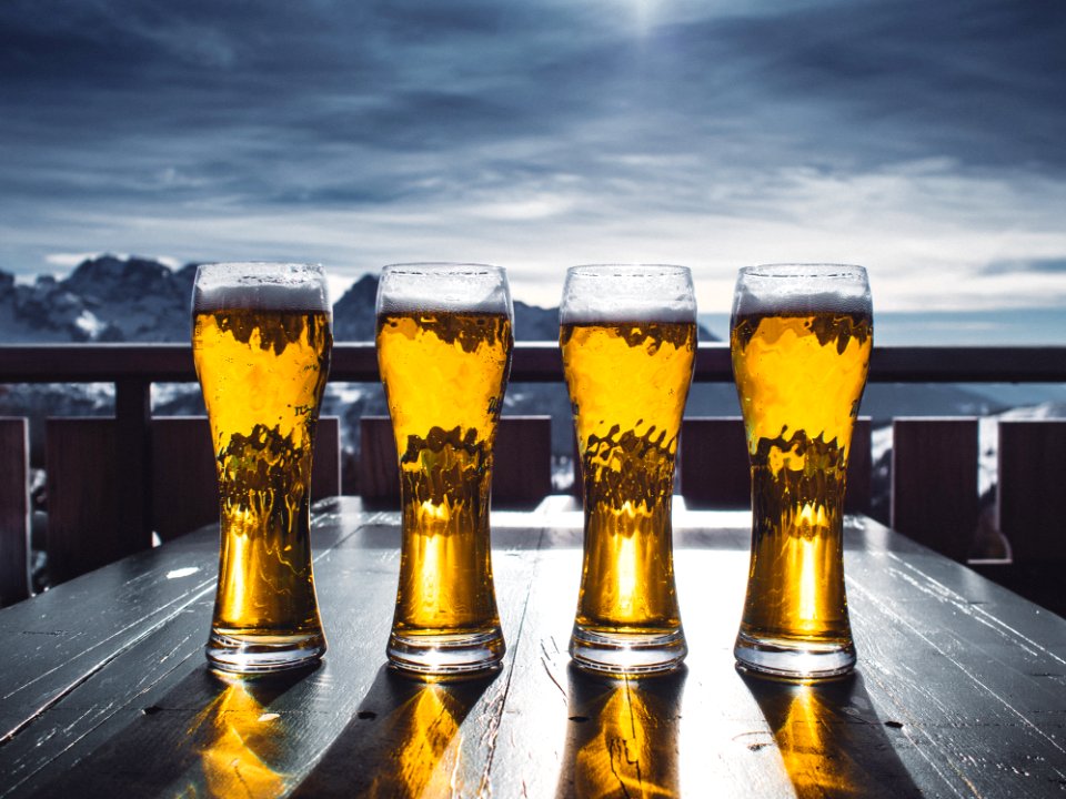 Four Pint Glasses Filled With Beer