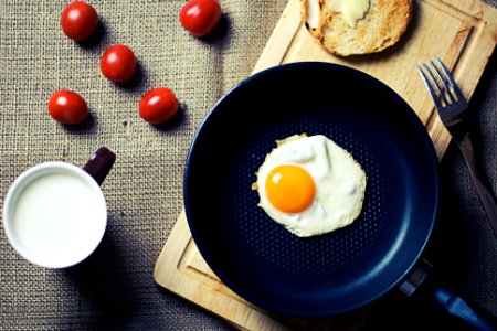 Fried Egg in Frying Pan Beside Mug photo