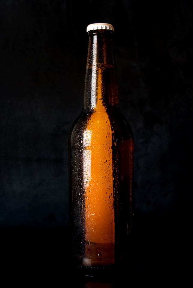 Amber Glass Bottle Standing on Black Surface