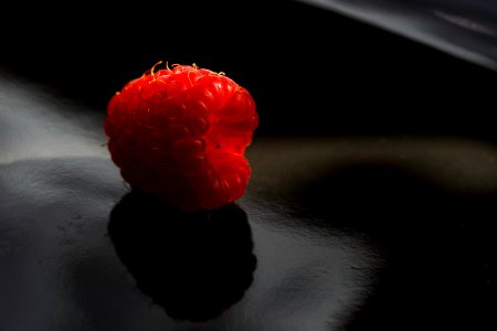 Close-up Photography of Red Cranberry on Black Surface