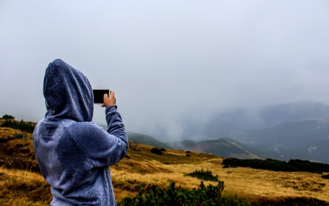Person Taking Photo of Mountain