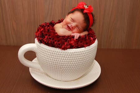 Newborn cup of tea smile photo