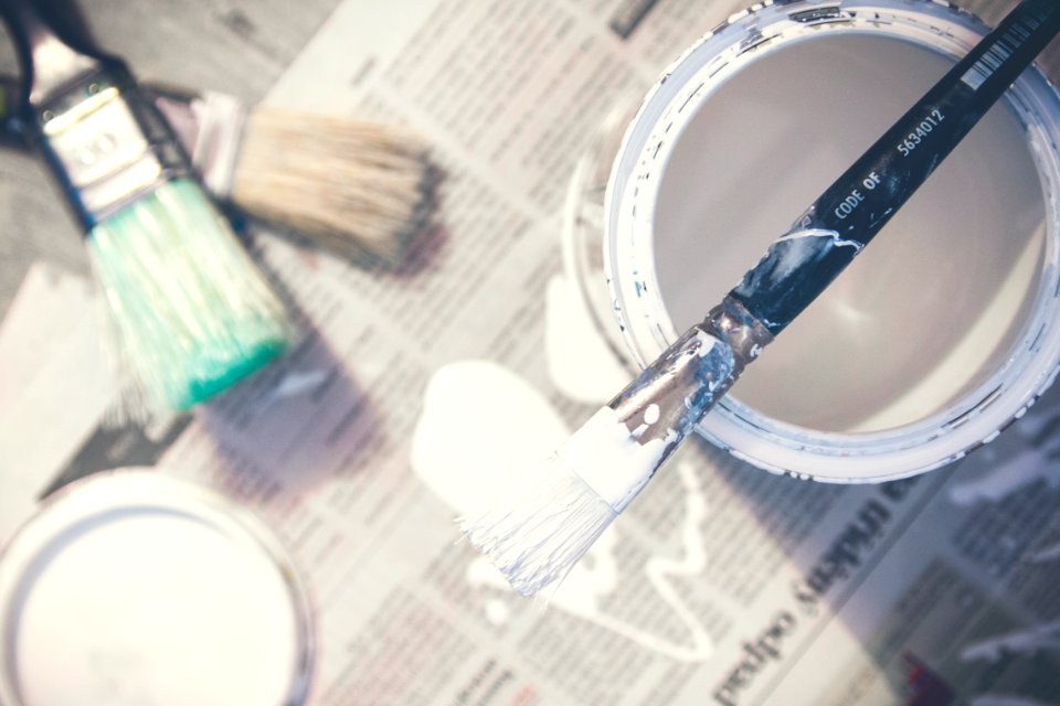 Black Paintbrush and White Paint